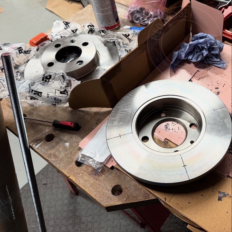 Marking up the brake discs ready for drilling holes to accommodate the threaded bar.